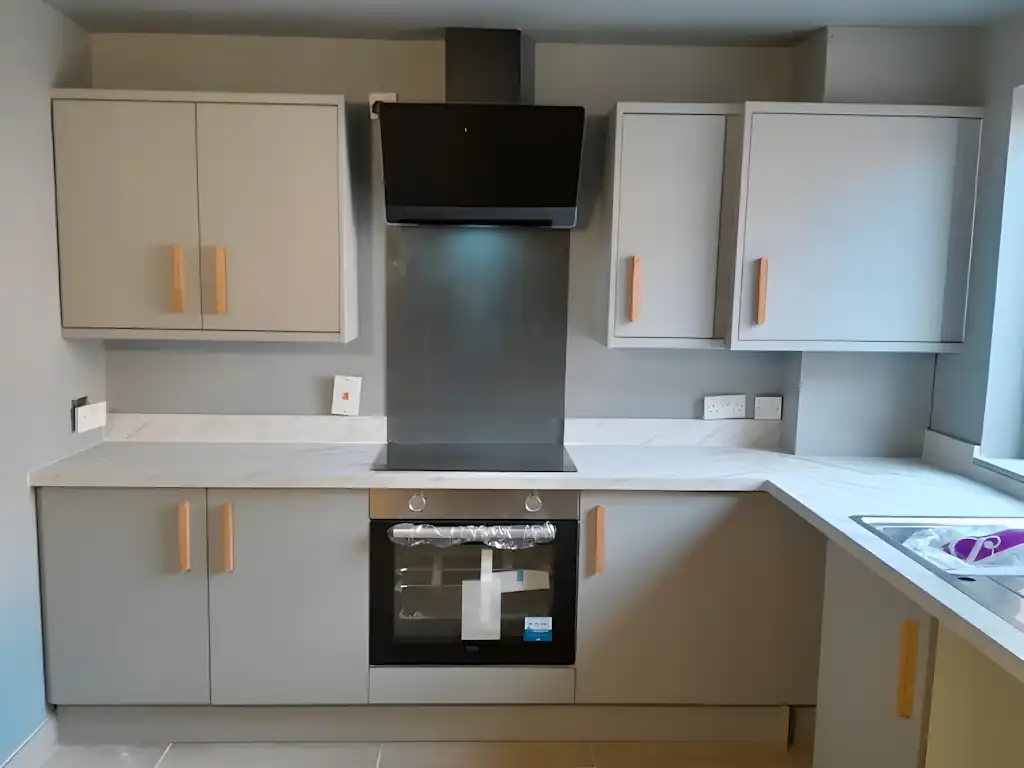 Small Newtownards kitchen modified to accommodate pipework and a gas boiler